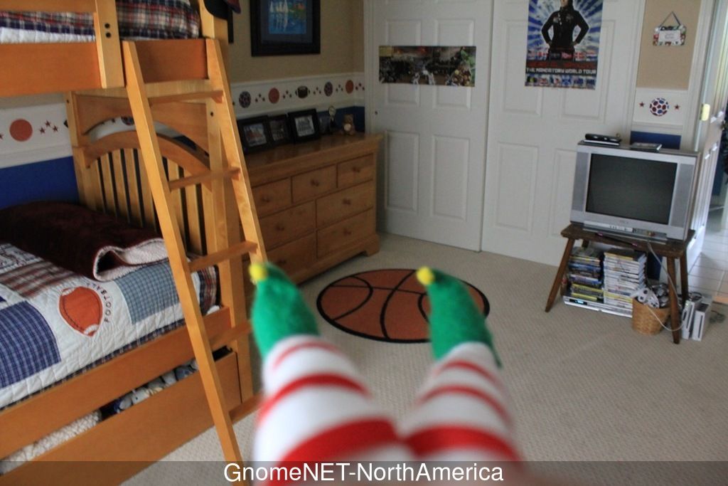 Photo taken by a Gnome. We see the Gnome feets and a bedroom. The Gnome is probably sitted on a shelf.